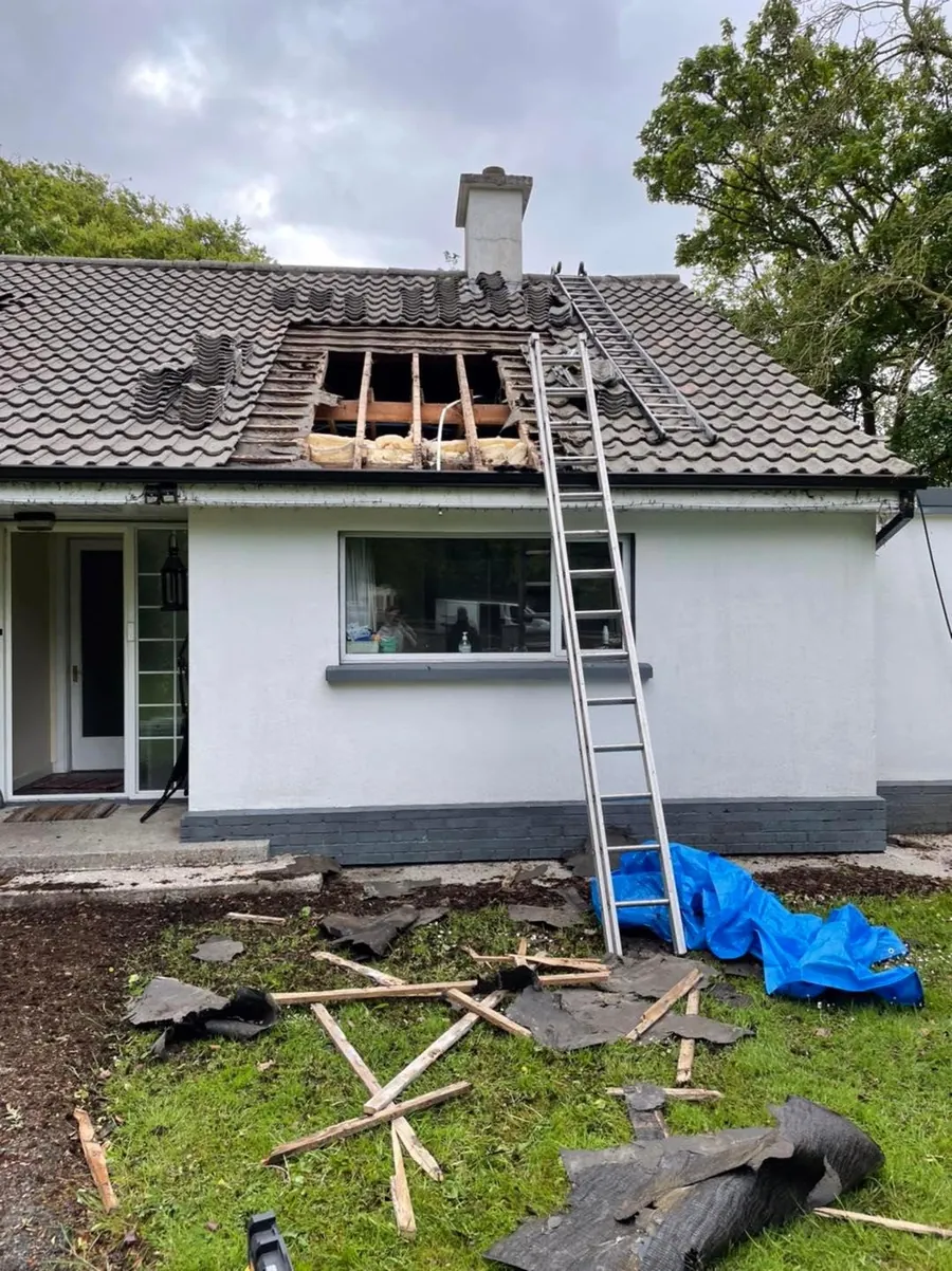 Bungalow roof opened for repairs with a ladder up, Flaherty Roof and Driveways