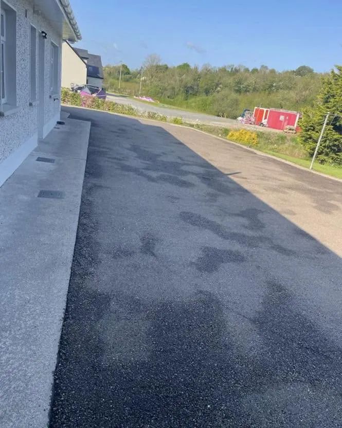 Freshly sealed driveway along the side of the house, Flaherty Roof and Driveways