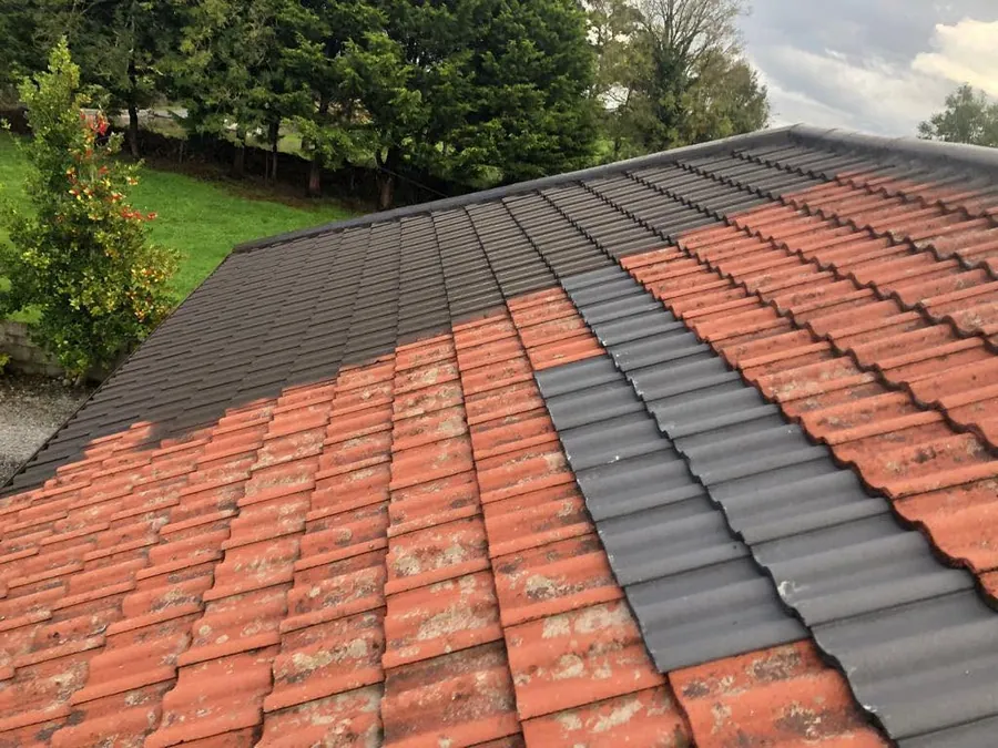 New dark tiles going on beside the old red tiles, Flaherty Roof and Driveways