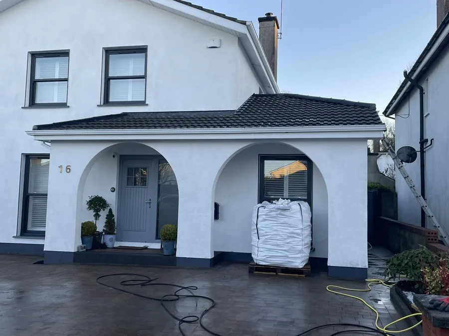 Rendered house with an arched porch during its re-roof, Flaherty Roof and Driveways