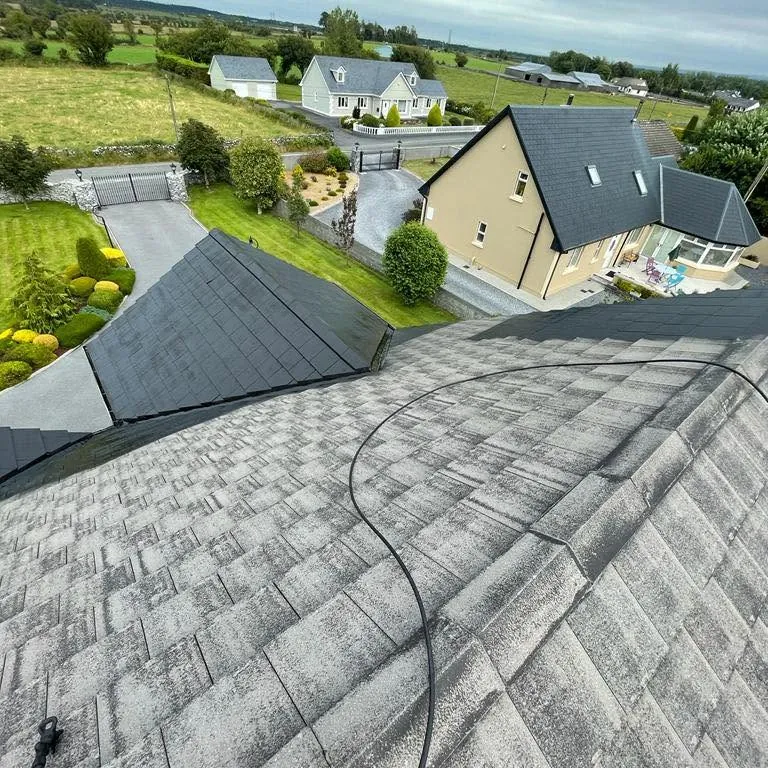 Concrete tile roof being cleaned with a pressure hose, Flaherty Roof and Driveways
