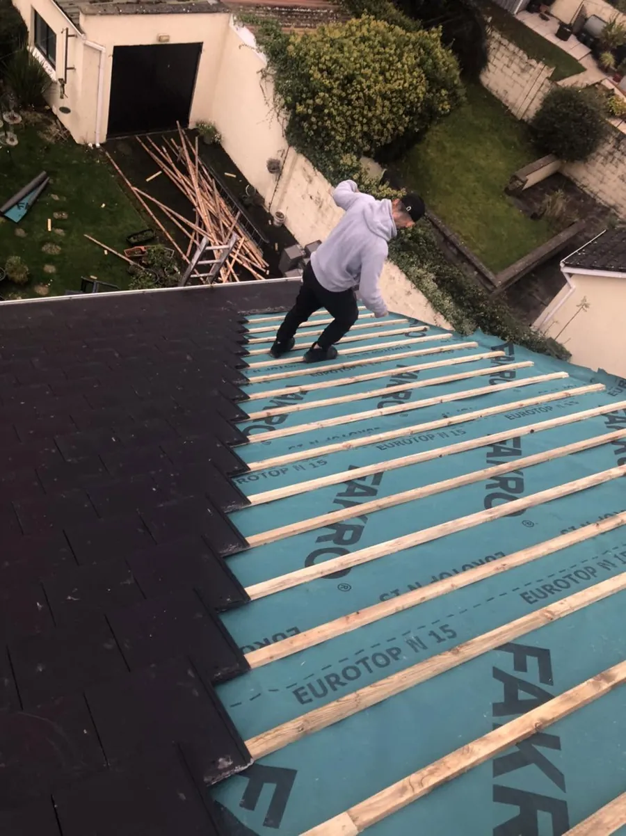 Roofer on new membrane on a semi-detached roof, Flaherty Roof and Driveways