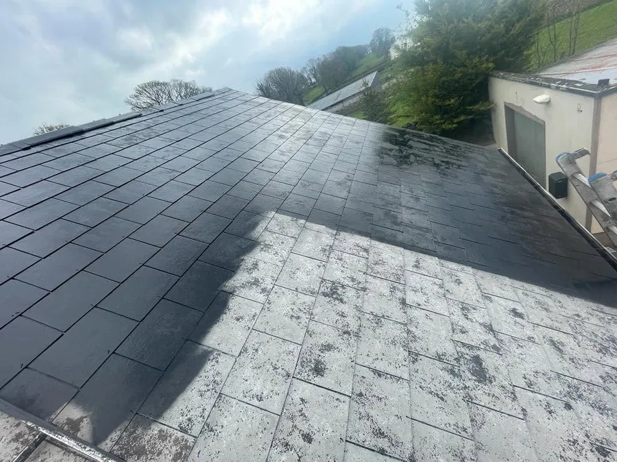 Slate roof half cleaned, the treated side dark against the weathered slates, Flaherty Roof and Driveways
