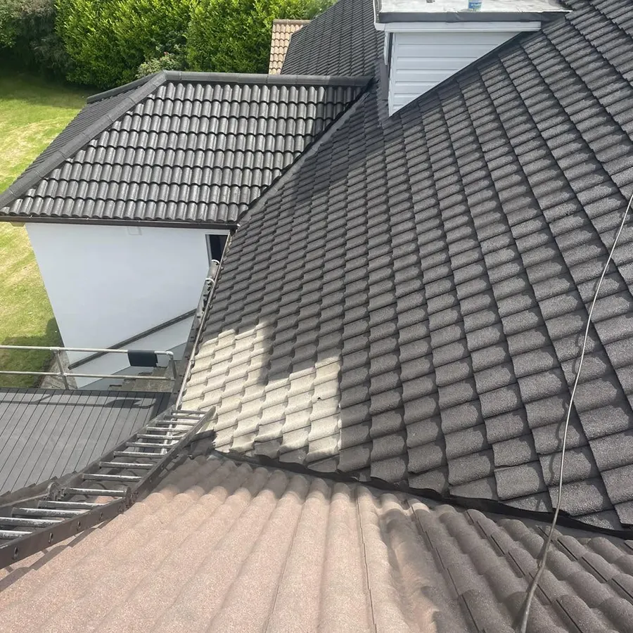 Tiled roof half re-coloured, new dark finish beside the old brown, Flaherty Roof and Driveways